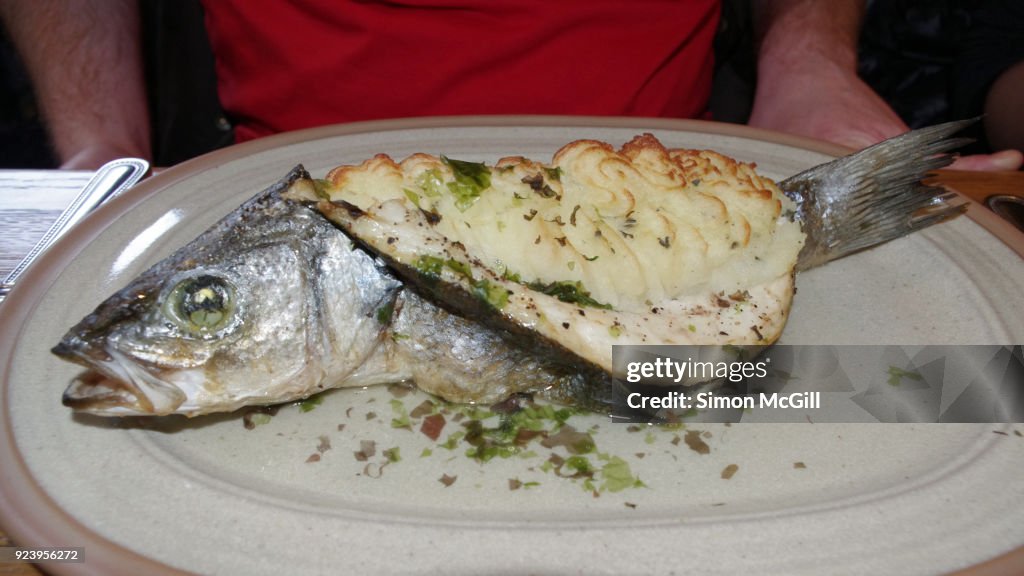 Baked fish filled with mashed potatoes