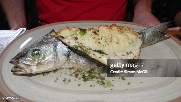 baked fish filled with mashed potatoes - bad-restaurant stock pictures, royalty-free photos & images