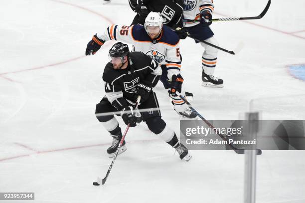 Torrey Mitchell of the Los Angeles Kings handles the puck against Mark Letestu of the Edmonton Oilers at STAPLES Center on February 24, 2018 in Los...