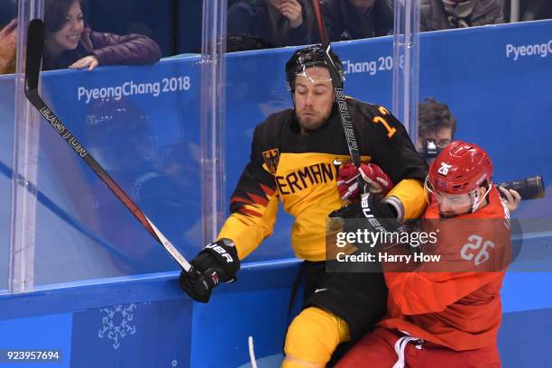 Vyacheslav Voinov of Olympic Athlete from Russia collides with Marcus Kink of Germany in the second period during the Men's Gold Medal Game on day...