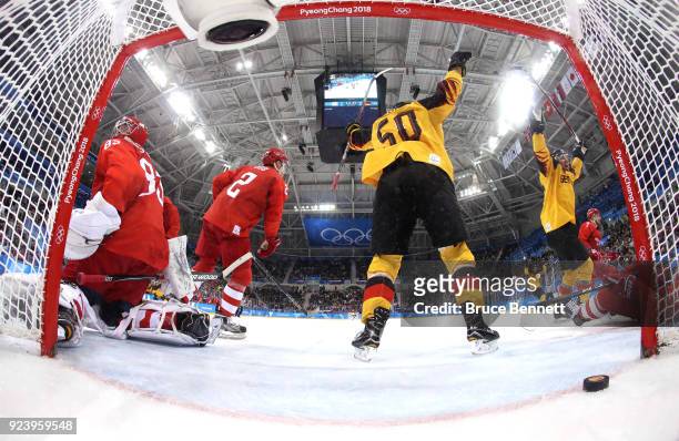 Brooks Macek and Patrick Hager of Germany celebrate after a goal by teammate Felix Schutz in the second period against Vasili Koshechkin of Olympic...