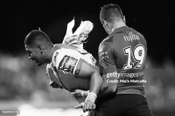 Nene MacDonald of the Dragons is tackled by Braidon Burns of the Rabbitohs during the NRL trial match between the South Sydney Rabbitohs and the St...