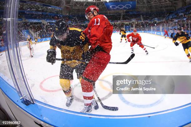 Yannic Seidenberg of Germany and Sergei Andronov of Olympic Athlete from Russia collide in the third period during the Men's Gold Medal Game on day...