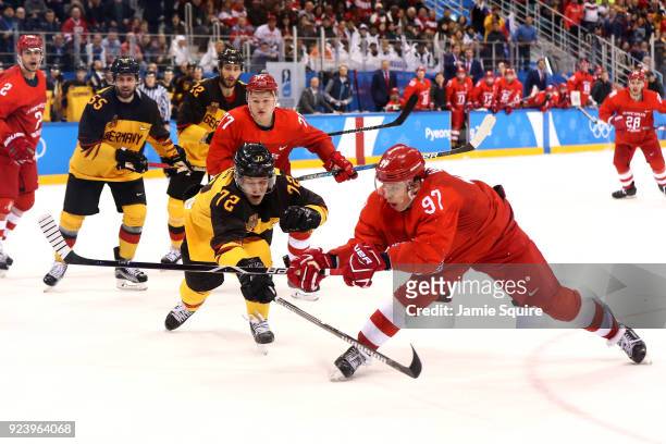 Nikita Gusev of Olympic Athlete from Russia shoots and scores against Dominik Kahun of Germany in the third period during the Men's Gold Medal Game...