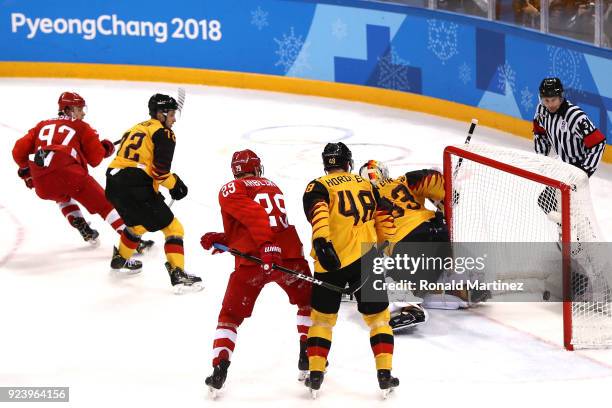 Nikita Gusev of Olympic Athlete from Russia shoots and scores against Dominik Kahun and Danny Aus Den Birken of Germany in the third period during...