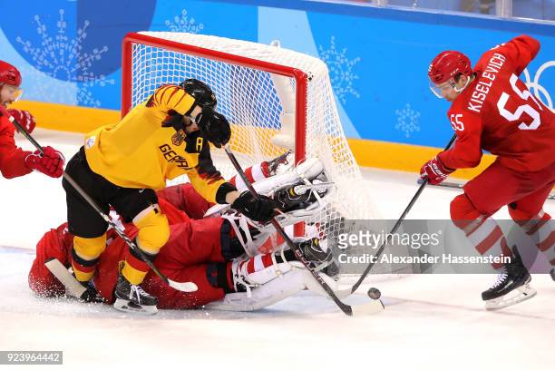 Patrick Hager of Germany attempts a shot against Vasili Koshechkin and Bogdan Kiselevich of Olympic Athlete from Russia in the third period during...