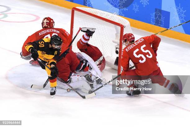 Patrick Hager of Germany attempts a shot against Vasili Koshechkin and Bogdan Kiselevich of Olympic Athlete from Russia in the third period during...