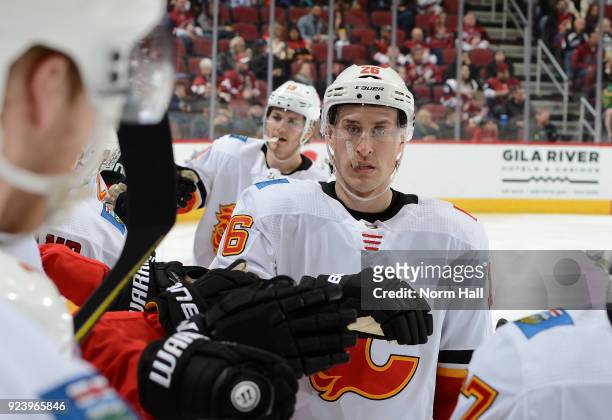 Michael Stone of the Calgary Flames celebrates a goal with teammates on the bench against the Arizona Coyotes at Gila River Arena on February 22,...
