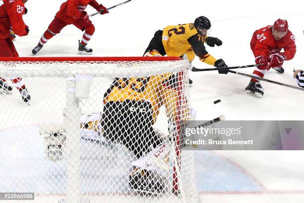 Nikita Gusev of Olympic Athlete from Russia shoots and scores against Dominik Kahun and Danny Aus Den Birken of Germany in the third period during...