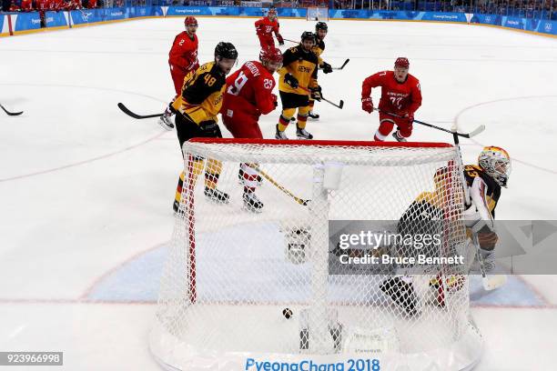 Nikita Gusev of Olympic Athlete from Russia shoots and scores against Dominik Kahun and Danny Aus Den Birken of Germany in the third period during...