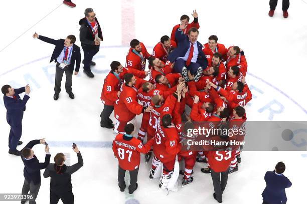 Gold medal winners Olympic Athletes from Russia lift head coach Oleg Znarok over center ice after defeating Germany 4-3 in overtime during the Men's...