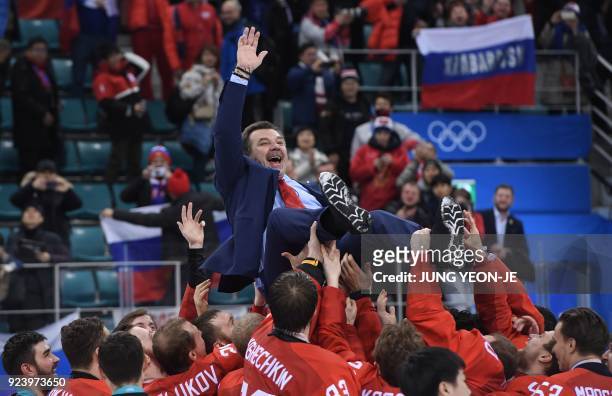 The Olympic Athletes from Russia's head coach Oleg Znarok is carried by his players after the medal ceremony after they won the men's gold medal ice...