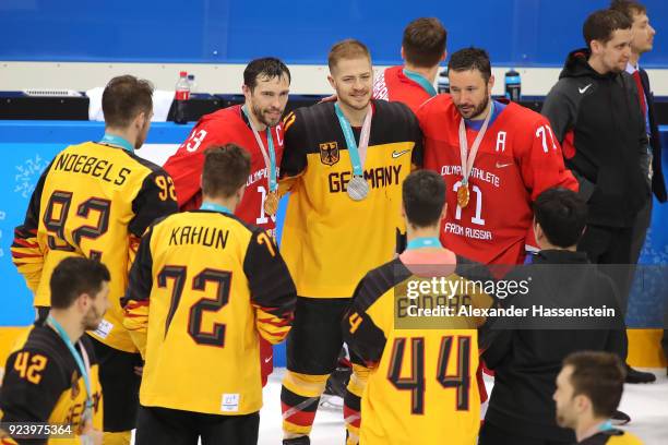 Silver medal winner Moritz Muller of Germany poses with gold medal winners Pavel Datsyuk and Ilya Kovalchuk of Olympic Athlete from Russia after the...
