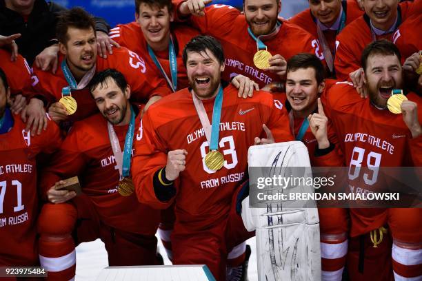 The Olympic Athletes from Russia's team poses with their gold medals after the medal ceremony after the men's gold medal ice hockey match between the...