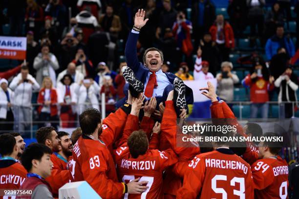 Gold medallists from the Olympic Athletes from Russia carry their head coach Oleg Znarok after the medal ceremony after the men's gold medal ice...