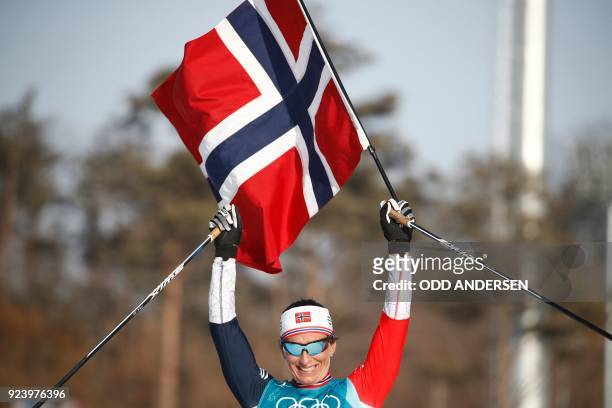 Norway's Marit Bjoergen celebrates her gold medal win in the women's 30km cross country mass start classic at the Alpensia cross country ski centre...