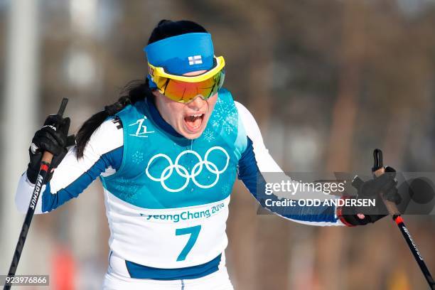 Finland's Krista Parmakoski celebrates her silver medal win at the finish line for the women's 30km cross country mass start classic at the Alpensia...