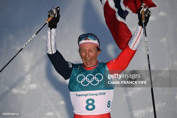 Norway's Marit Bjoergen celebrates winning the women's 30km cross country mass start classic at the Alpensia cross country ski centre during the...