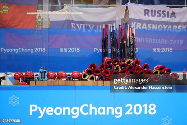 Helmets, sticks and gloves sit on the bench after Olympic Athletes from Russia defeated Germany 4-3 in overtime during the Men's Gold Medal Game on...