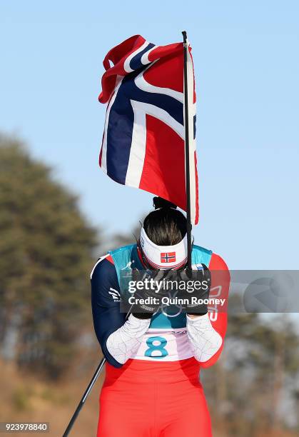 Marit Bjoergen of Norway celebrates winning the Ladies' 30km Mass Start Classic on day sixteen of the PyeongChang 2018 Winter Olympic Games at...