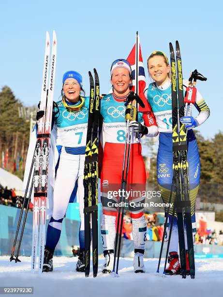 Second placed Krista Parmakoski of Finland, first placed Marit Bjoergen of Norway and third placed Stina Nilsson of Sweden celebrate following the...