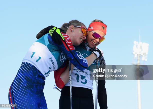 Sadie Bjornsen of the United States and Stefanie Boehler of Germany react after crossing the finish line during the Ladies' 30km Mass Start Classic...