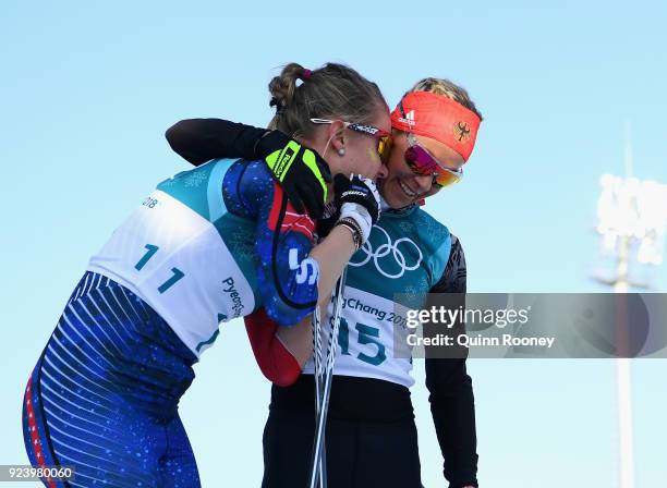 Sadie Bjornsen of the United States and Stefanie Boehler of Germany react after crossing the finish line during the Ladies' 30km Mass Start Classic...