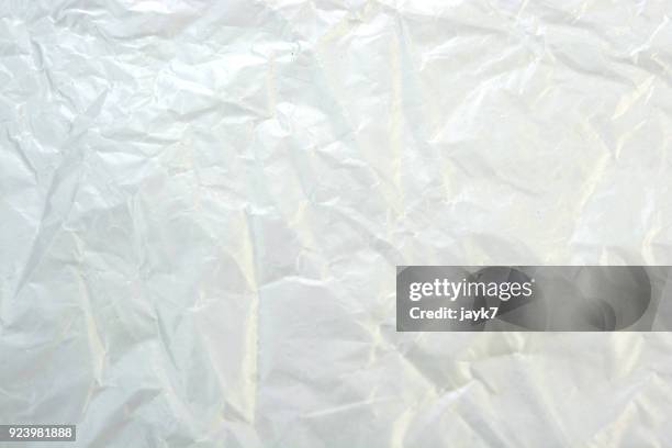 crumpled plastic sheet - plastic folie stockfoto's en -beelden