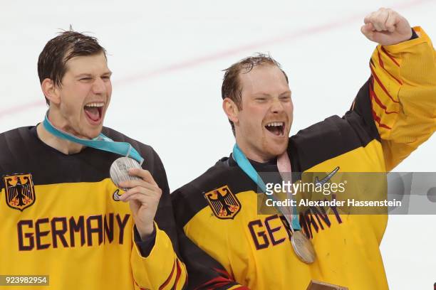 Silver medal winners Frank Mauer and Danny Aus Den Birken react during the medal ceremony after being defeated by Olympic Athletes from Russia 4-3 in...