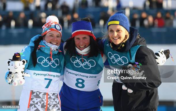 Second placed Krista Parmakoski of Finland, first placed Marit Bjoergen of Norway and third placed Stina Nilsson of Sweden celebrate following the...