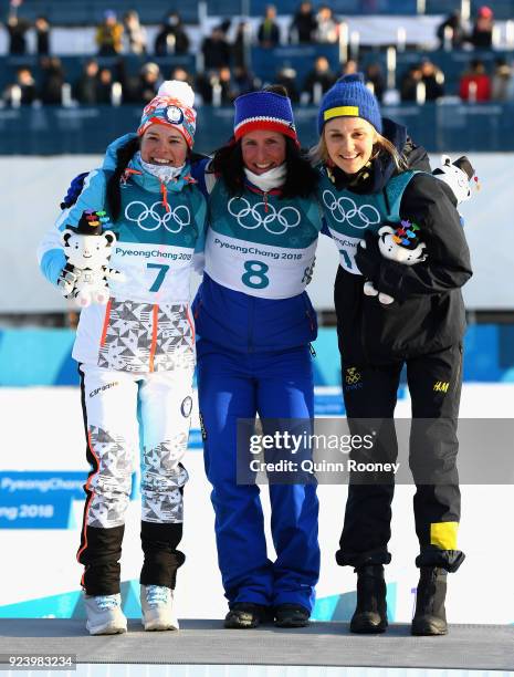 Second placed Krista Parmakoski of Finland, first placed Marit Bjoergen of Norway and third placed Stina Nilsson of Sweden celebrate following the...