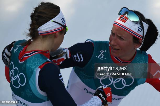 Norway's Marit Bjoergen talks to teammate Ingvild Flugstad Oestberg after the women's 30km cross country mass start classic at the Alpensia cross...