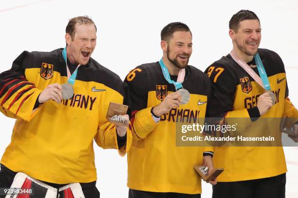 Silver medal winners Danny Aus Den Birken , Yannic Seidenberg and Patrick Reimer of Germany react during the medal ceremony after being defeated by...