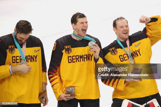Silver medal winners Matthias Plachta , Frank Mauer and Danny Aus Den Birken react during the medal ceremony after being defeated by Olympic Athletes...