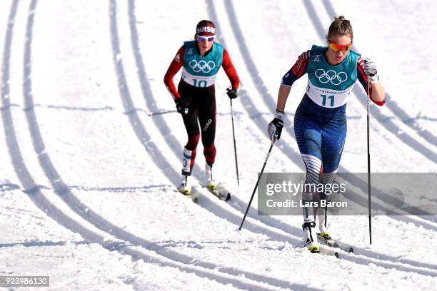 Sadie Bjornsen of the United States and Nathalie Von Siebenthal of Switzerland compete during the Ladies' 30km Mass Start Classic on day sixteen of...