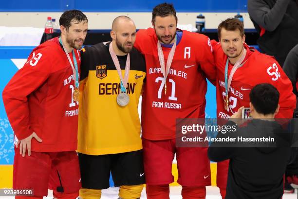 Silver medal winner Felix Schuetz of Germany poses with gold medal winners Pavel Datsyuk, Ilya Kovalchuk and Sergei Shirokov of Olympic Athlete from...
