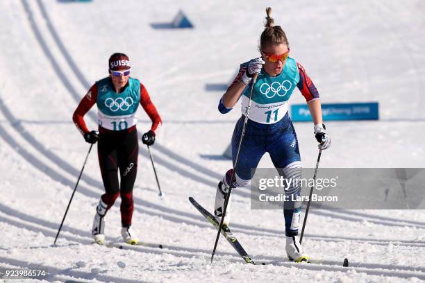 Sadie Bjornsen of the United States and Nathalie Von Siebenthal of Switzerland compete during the Ladies' 30km Mass Start Classic on day sixteen of...