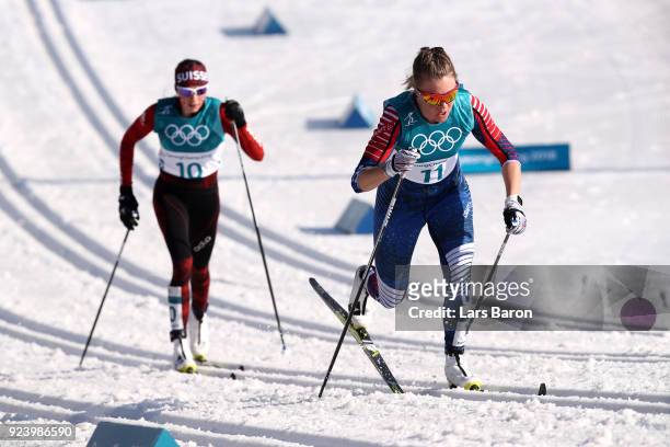 Sadie Bjornsen of the United States and Nathalie Von Siebenthal of Switzerland compete during the Ladies' 30km Mass Start Classic on day sixteen of...