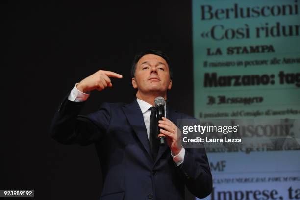 The Italian politician and leader of the Democratic Party Matteo Renzi holds a political rally while showing the name of Berlusconi behind him on...