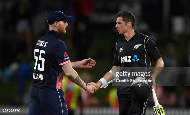 New Zealand batsman Mitchell Santner is congratulated by Ben Stokes after the 1st ODI between New Zealand and England at Seddon Park on February 25,...
