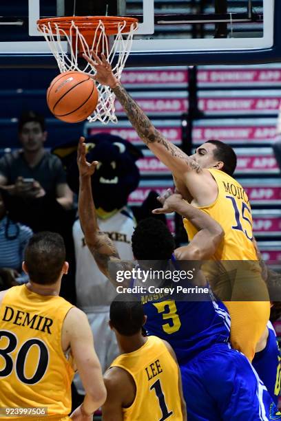 Sammy Mojica of the Drexel Dragons fouls Anthony Mosley of the Delaware Fightin Blue Hens during the second half at the Daskalakis Athletic Center on...