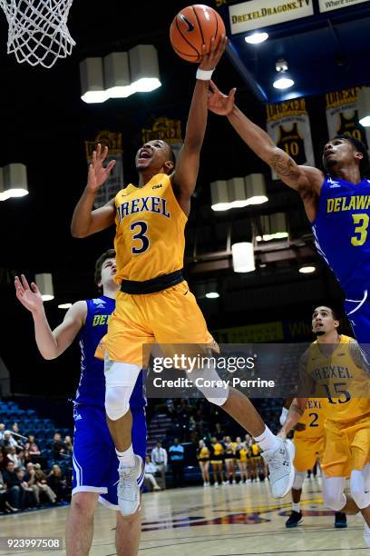 Troy Harper of the Drexel Dragons drives to the basket against Anthony Mosley of the Delaware Fightin Blue Hens during the second half at the...