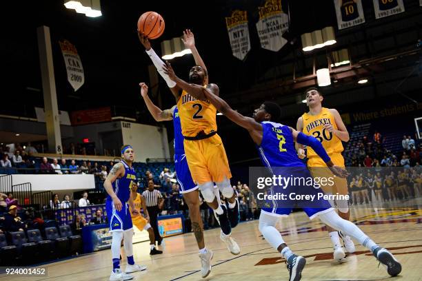 Tramaine Isabell of the Drexel Dragons picks up the basket and the foul against Ryan Allen of the Delaware Fightin Blue Hens during the second half...