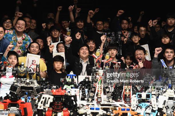 Technicians pose with their robots during the 32nd ROBO-ONE tournament on February 25, 2018 in Tokyo, Japan. According to the organizer, the...