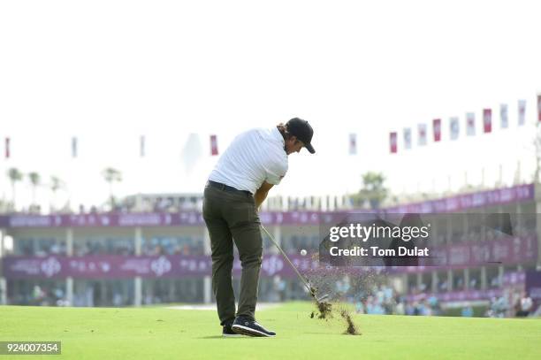 Eddie Pepperell of England hits an approach shot on the 18th hole during the final round of the Commercial Bank Qatar Masters at Doha Golf Club on...