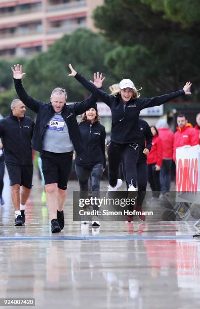 Laureus Academy Chairman Sean Fitzpatrick and Laureus Academy member Nadia Comaneci cross the finish line during the Laureus Sport for Good Run prior...