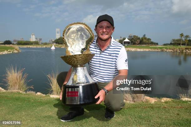 Eddie Pepperell of England poses with the trophy following his victory during the final round of the Commercial Bank Qatar Masters at Doha Golf Club...