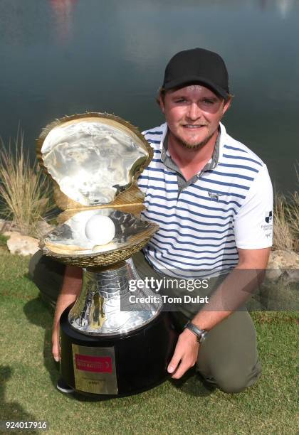 Eddie Pepperell of England poses with the trophy following his victory during the final round of the Commercial Bank Qatar Masters at Doha Golf Club...