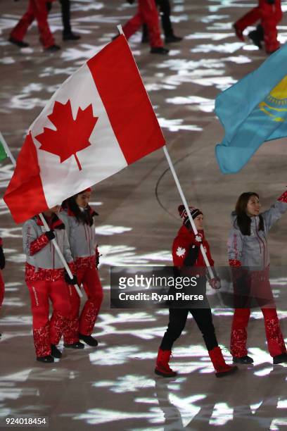 Flag bearer Kim Boutin of Canada walks in the Parade of Athletes during the Closing Ceremony of the PyeongChang 2018 Winter Olympic Games at...