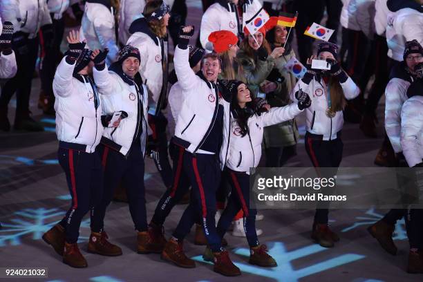 Madison Chock and Evan Bates walk with Team USA in the Parade of Athletes during the Closing Ceremony of the PyeongChang 2018 Winter Olympic Games at...